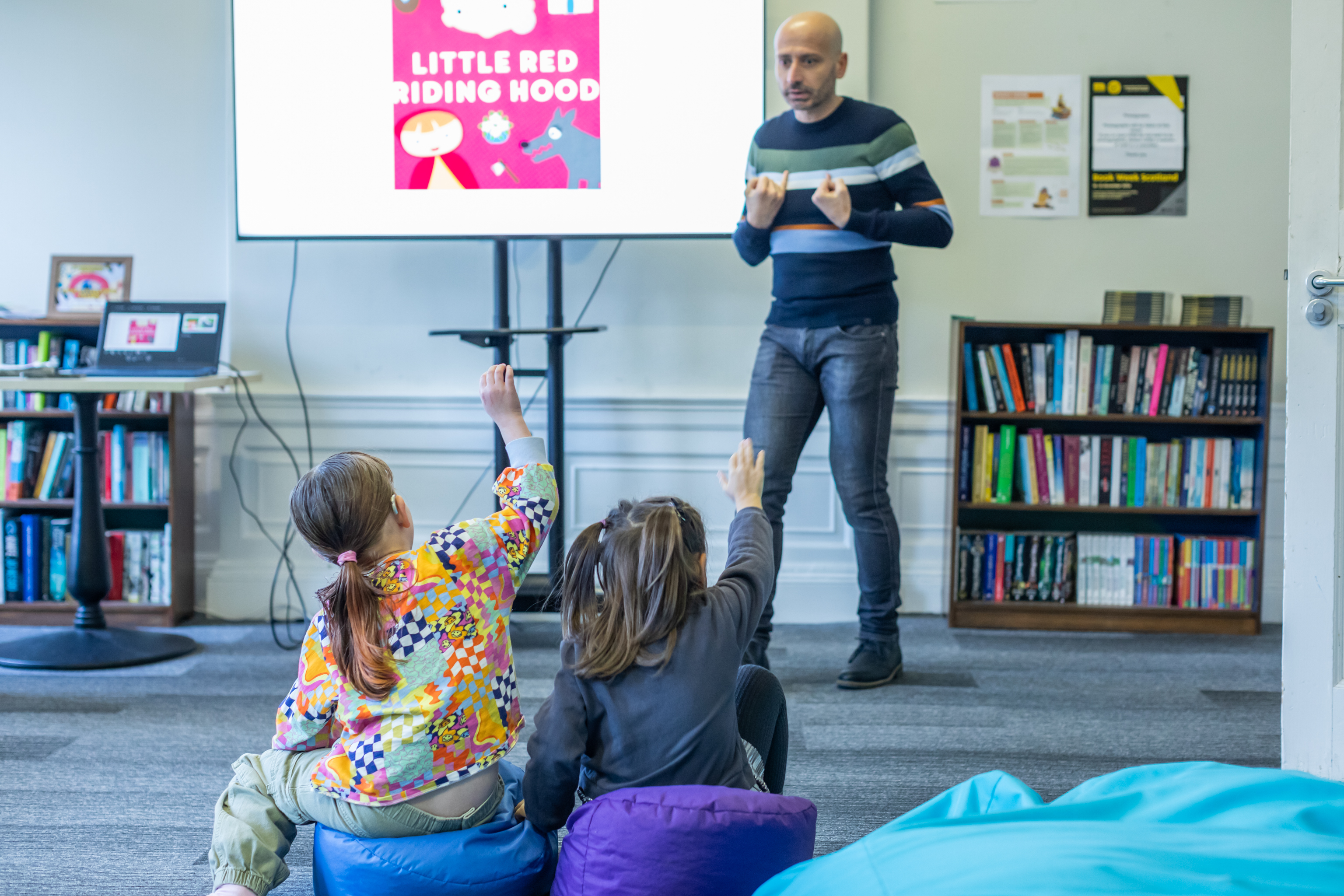 Storyteller and two children watching him
